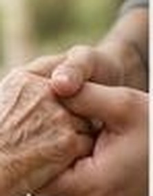 An older person's hand held in support